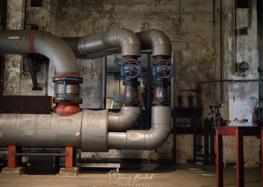 Rohrleitungssystem mit Ventilen in einem industriellen Raum.